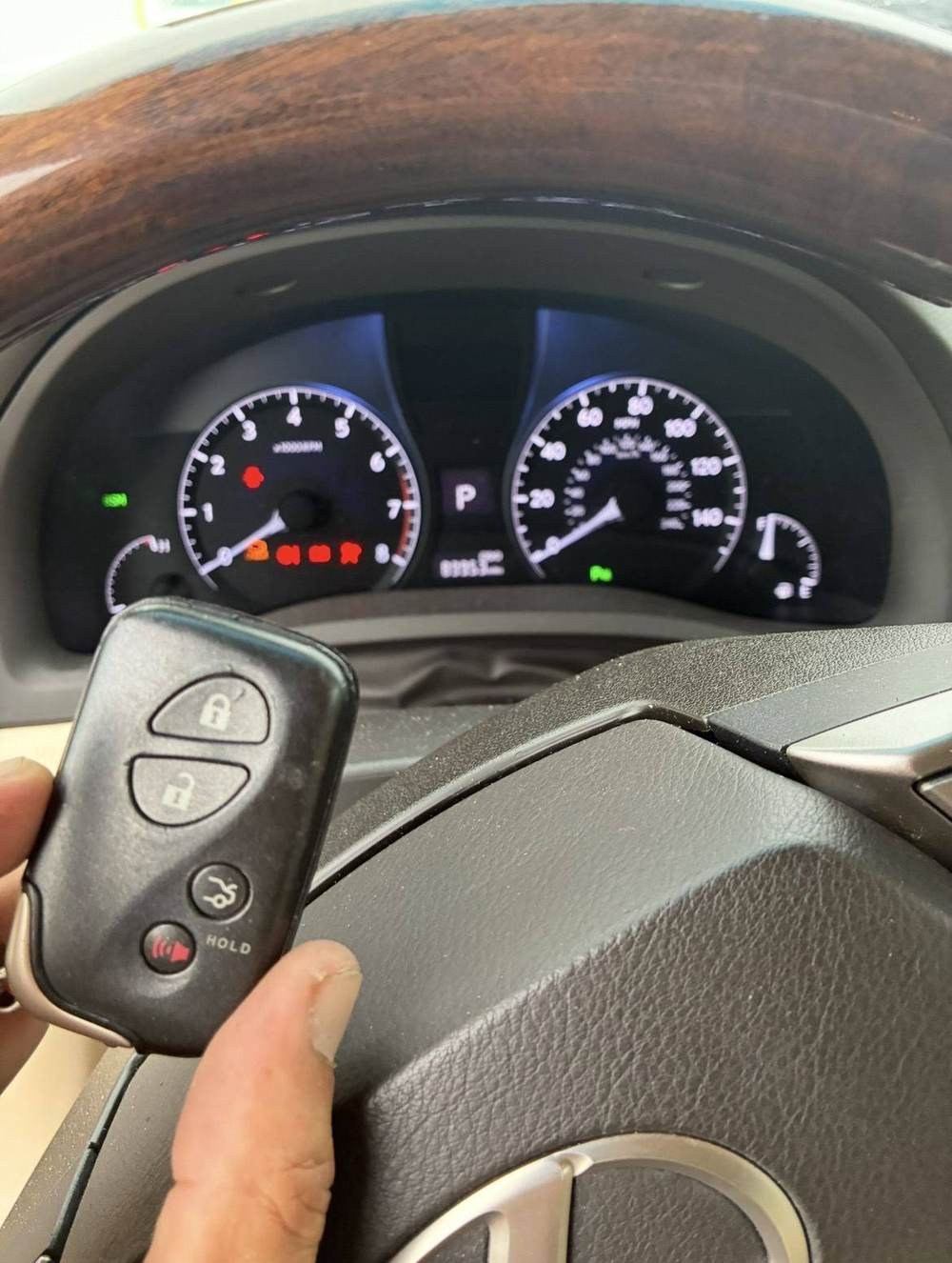 IK7 Locksmith technician opening a locked vehicle door during a car lockout call in Rockwall, TX